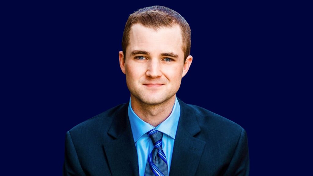 Cam Headshot Blue Cam Rogers Headshot
